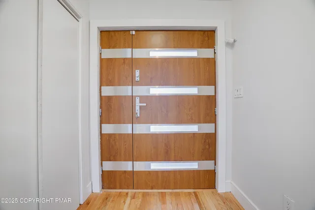a living room with furniture and floor to ceiling windows