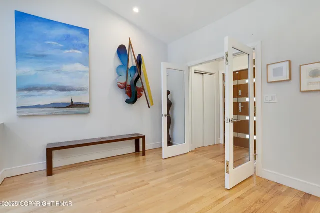 a living room with furniture and a painting