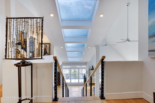 a living room with fireplace furniture and a large window