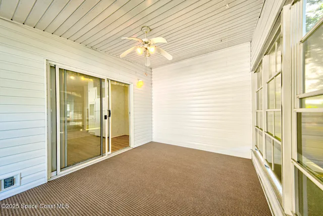 a view of an empty room with a chandelier
