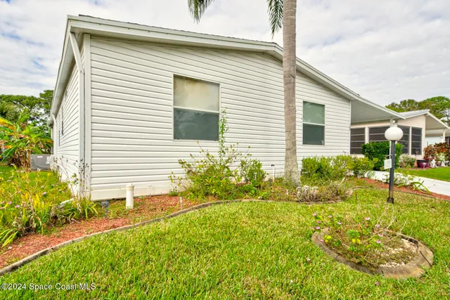 a view of a house with a yard and plants