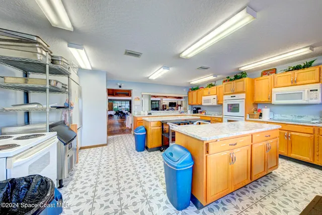 a kitchen with a stove a sink and a refrigerator