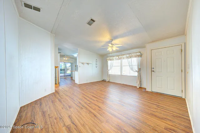 wooden floor in an empty room with a window