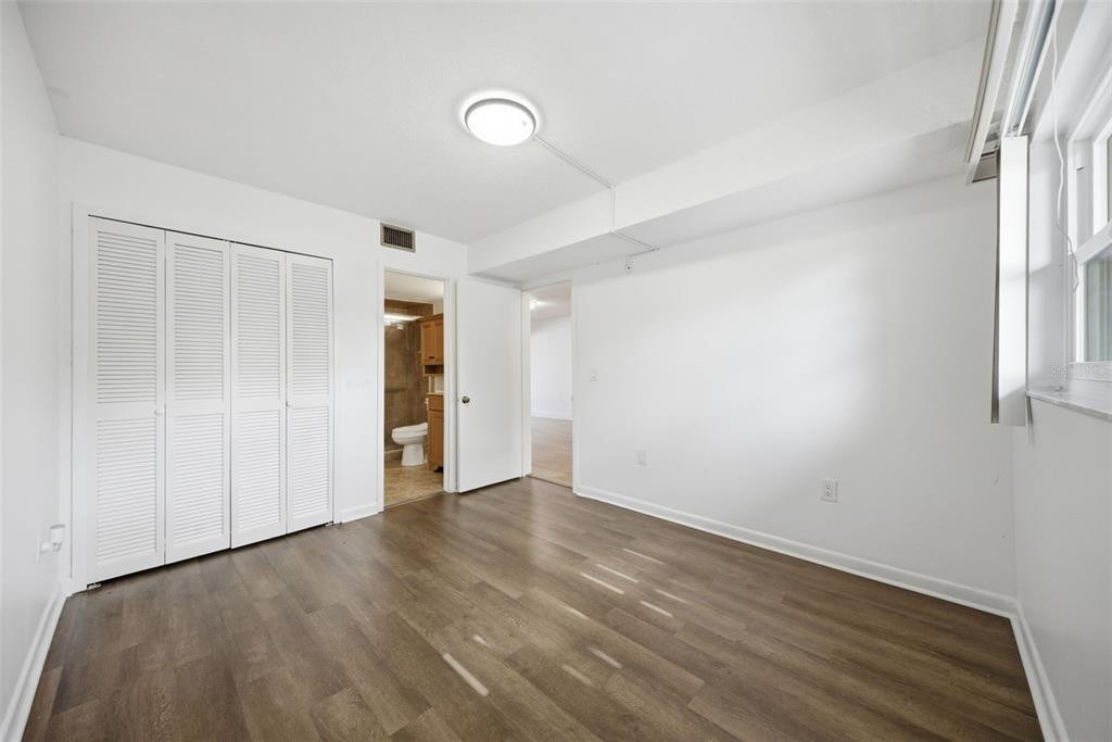141 Fernery Road, Unit A3 Lakeland, FL 33809 - Photo 12 of 40 an empty room with wooden floor and windows