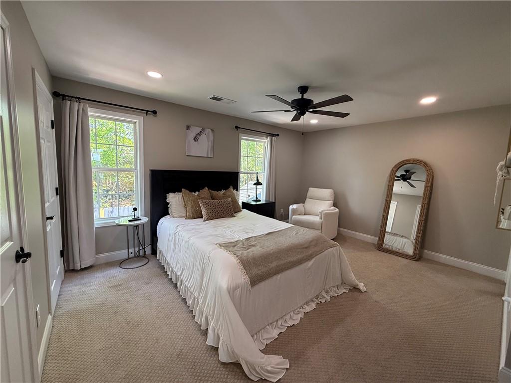 716 Manor Way, Unit 716 Cartersville, GA 30120 - Photo 13 of 21 a spacious bedroom with a bed and a chandelier