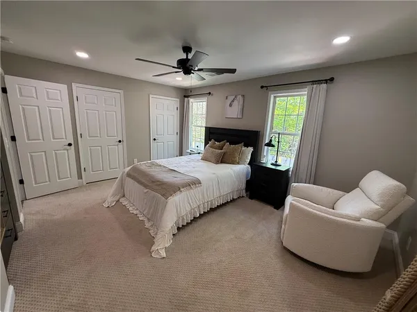 a bedroom with a bed couch and window