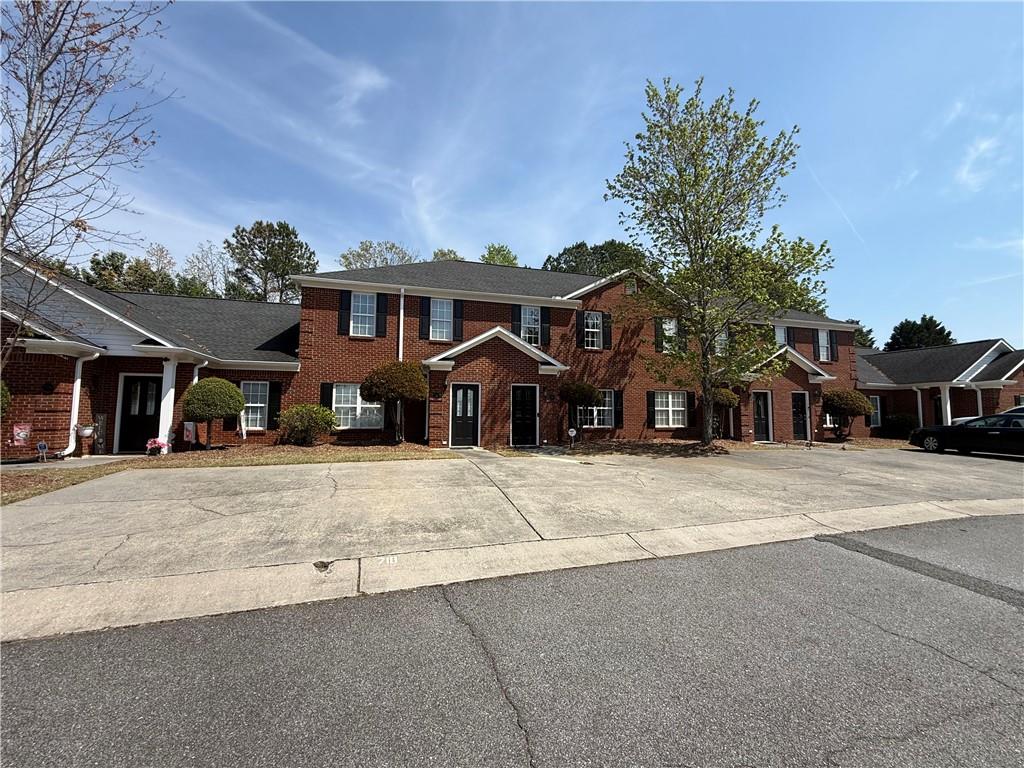 716 Manor Way, Unit 716 Cartersville, GA 30120 - Photo 2 of 21 a front view of a house with a yard and garage