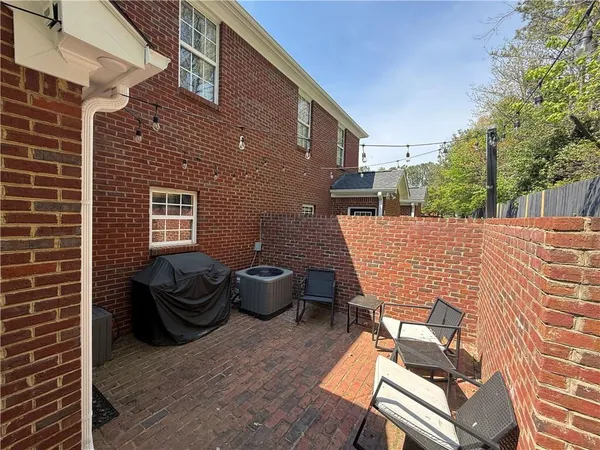 a view of a patio with couches chairs and a potted plant