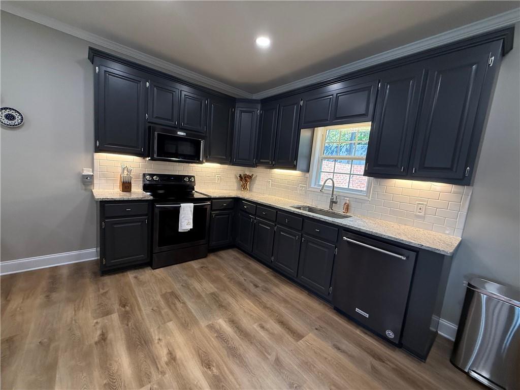 716 Manor Way, Unit 716 Cartersville, GA 30120 - Photo 9 of 21 a kitchen with stainless steel appliances granite countertop wooden cabinets a stove top oven a sink and dishwasher