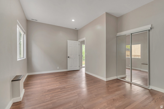 2154 Wasatch Boulevard Sandy, UT 84092 - Photo 51 of 55 Unfurnished bedroom featuring multiple windows, wood finished floors, recessed lighting, and a closet