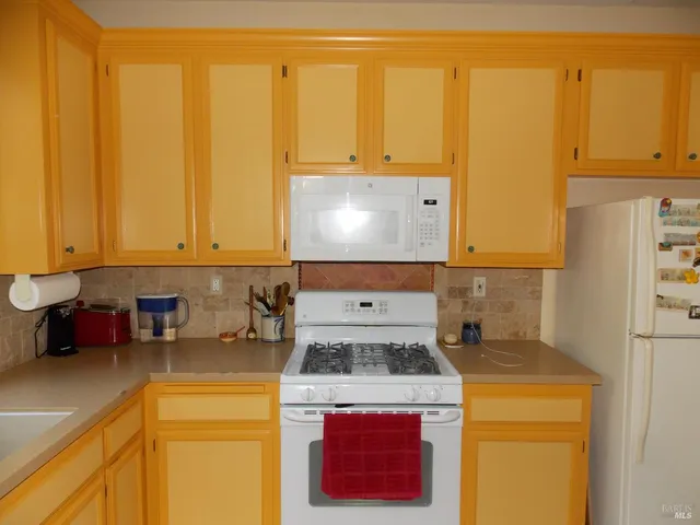a kitchen with a stove and a refrigerator