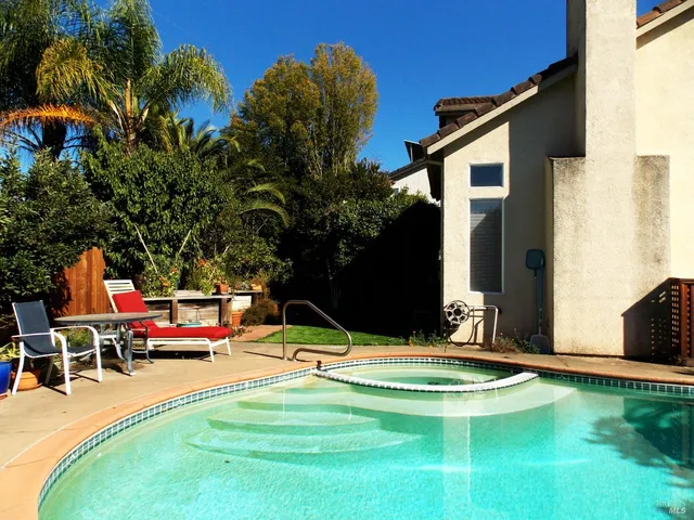 a view of a backyard with sitting area