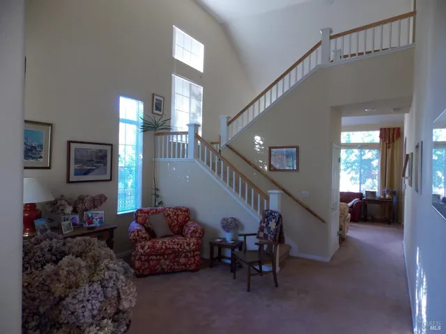 a living room with furniture and stairs