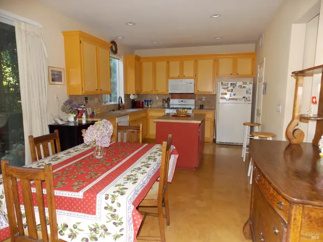 a room with furniture a large window and a dining table