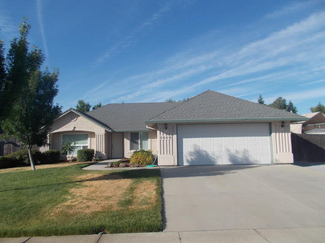 2649 Rhinestone Way Redding, CA 96001 - Photo 1 of 25 a front view of a house with a yard