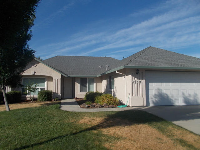 2649 Rhinestone Way Redding, CA 96001 - Photo 2 of 25 a front view of a house with a yard