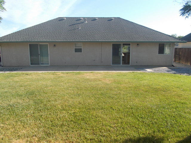 2649 Rhinestone Way Redding, CA 96001 - Photo 21 of 25 a front view of a house with a yard