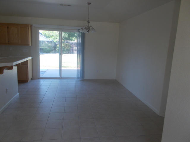 2649 Rhinestone Way Redding, CA 96001 - Photo 4 of 25 a view of an empty room and a kitchen