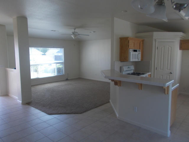 2649 Rhinestone Way Redding, CA 96001 - Photo 7 of 25 an empty room with windows and cabinet