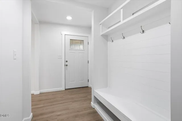 a view of hallway with wooden floor