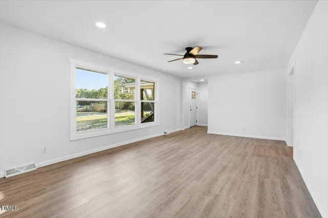 wooden floor in an empty room with a window