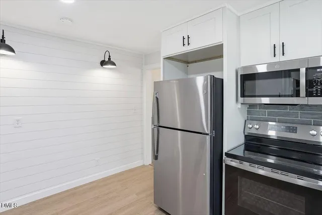 a metallic refrigerator freezer sitting in a kitchen