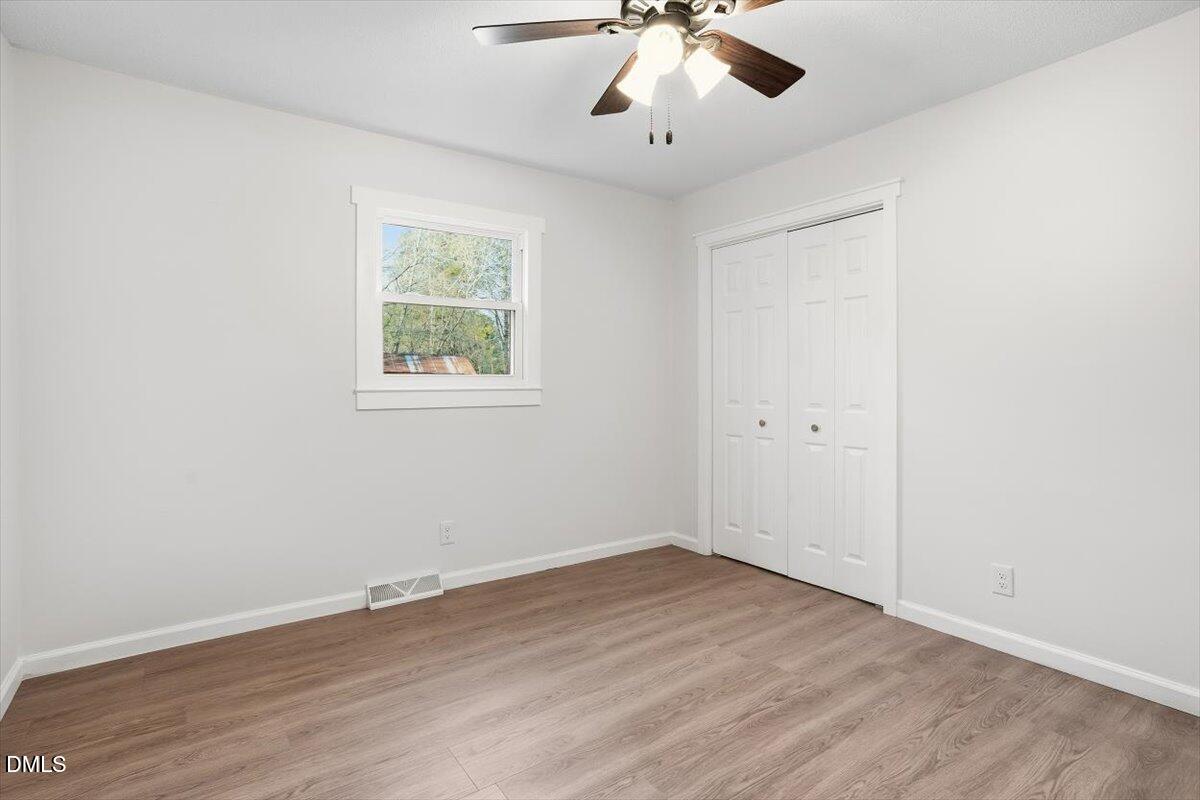 2609 Old Rte 22 Kenly, NC 27542 - Photo 28 of 43 a view of an empty room with wooden floor and a window
