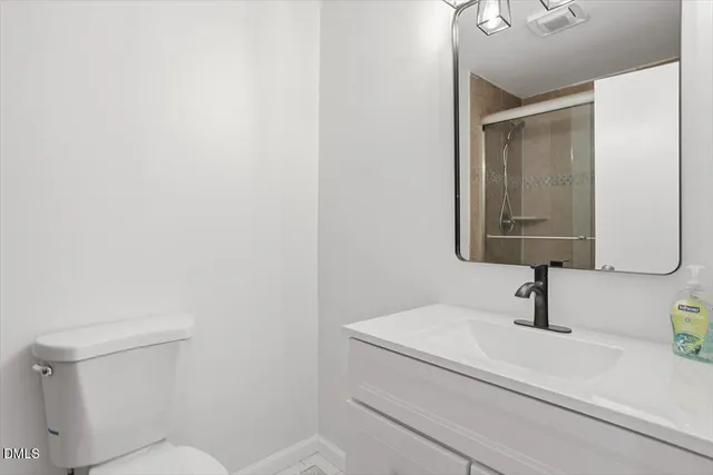 a bathroom with a sink a toilet and mirror