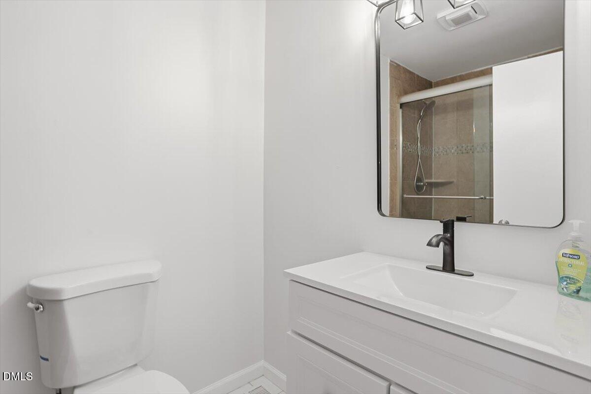 2609 Old Rte 22 Kenly, NC 27542 - Photo 29 of 43 a bathroom with a sink a toilet and mirror