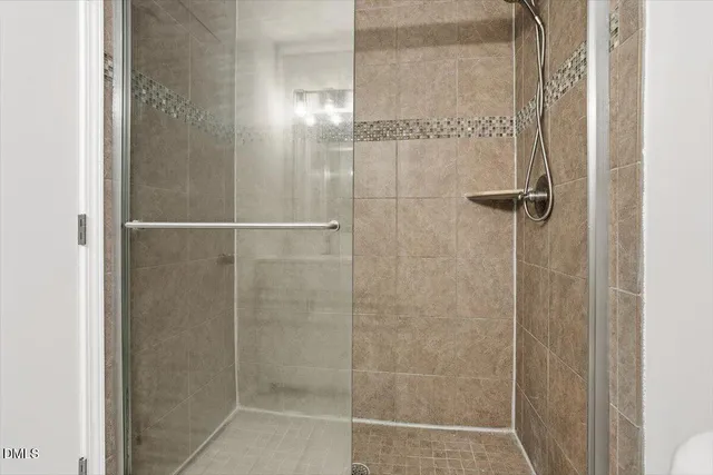 a bathroom with a glass shower door
