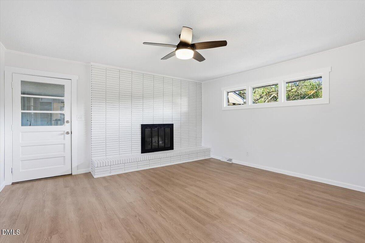 2609 Old Rte 22 Kenly, NC 27542 - Photo 7 of 43 an empty room with windows and fireplace