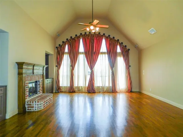 a view of room with window and wooden floor