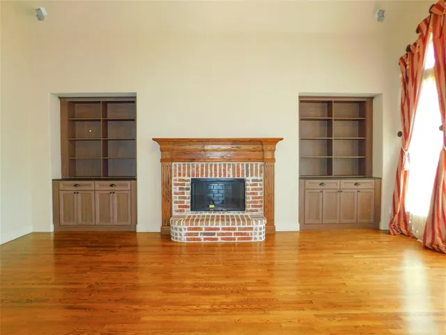 a view of a livingroom with a fireplace and window
