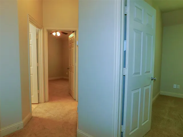 a view of a bathroom from a hallway