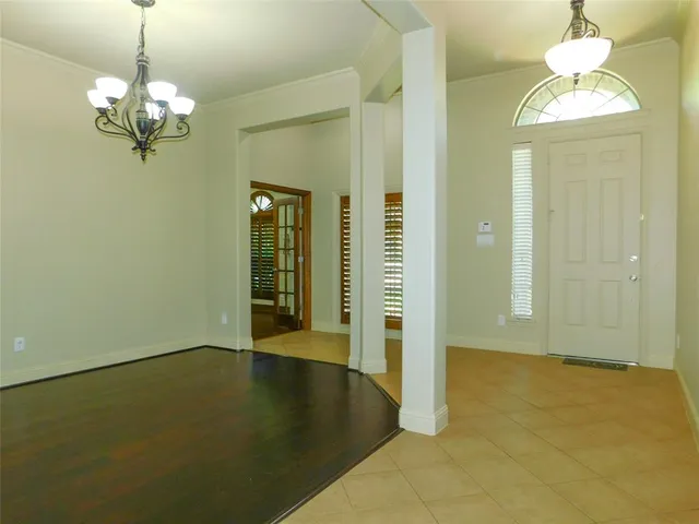 an empty room with a chandelier