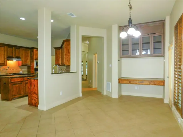 a view of a kitchen with a sink and dishwasher a refrigerator with wooden floor