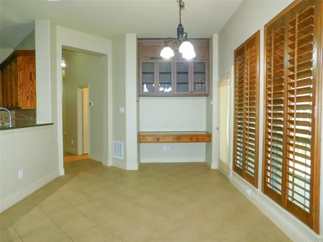 a view of a room with large windows and wooden floor