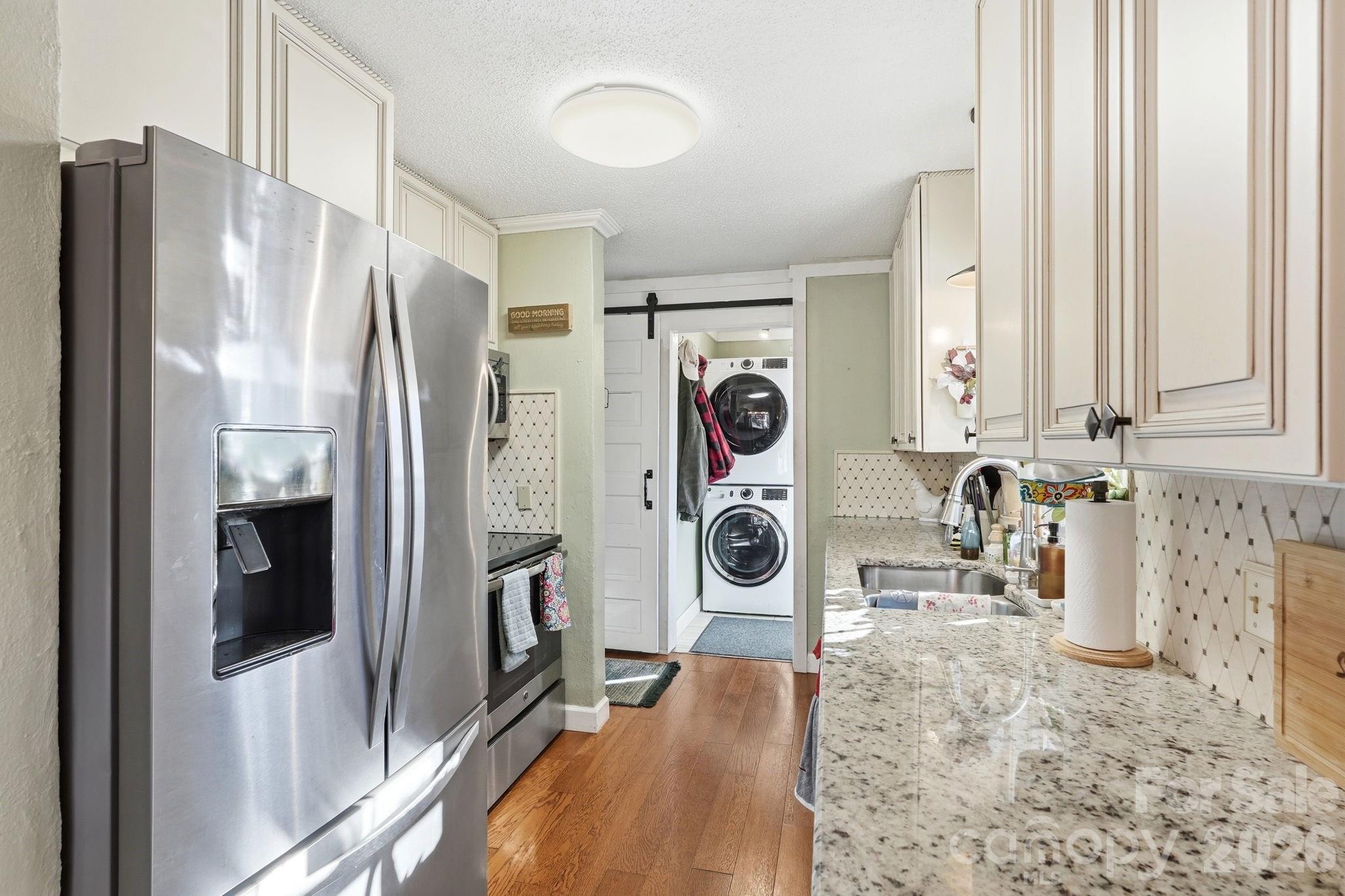 920 Ransom Road Winston-Salem, NC 27106 - Photo 12 of 35 a view of a kitchen with refrigerator and washer