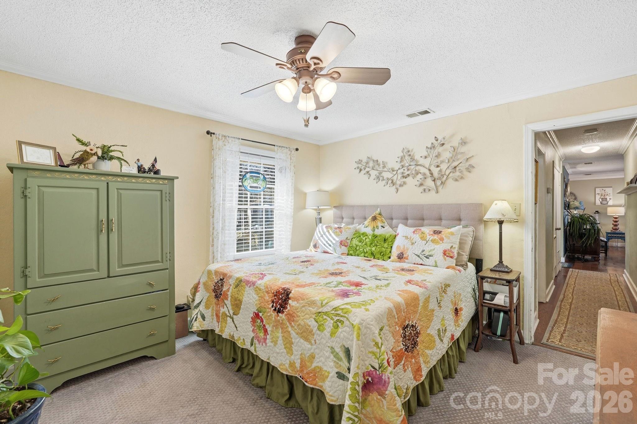 920 Ransom Road Winston-Salem, NC 27106 - Photo 15 of 35 a bedroom with a bed and a chandelier