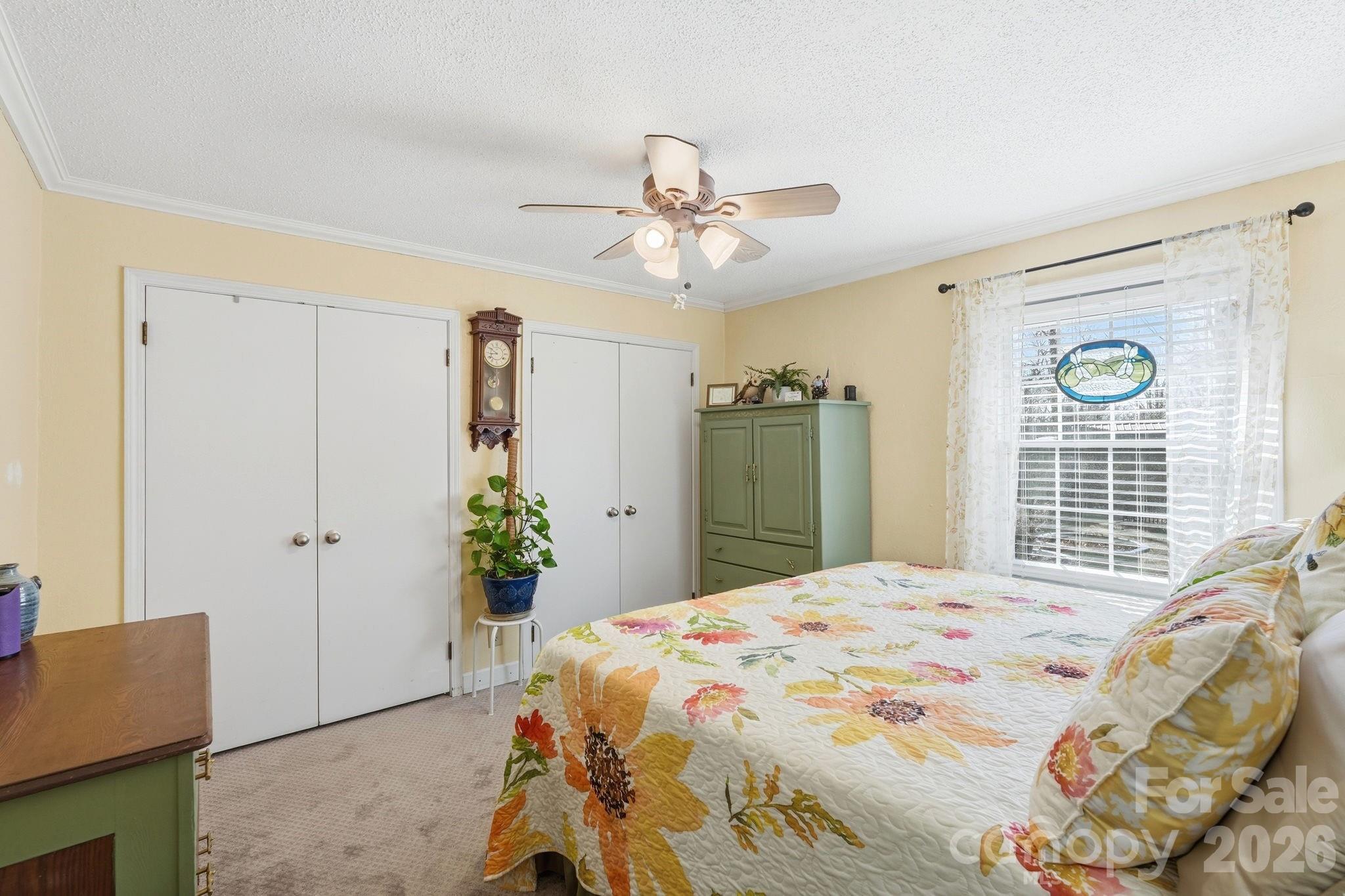920 Ransom Road Winston-Salem, NC 27106 - Photo 16 of 35 a bedroom with a bed and a chandelier
