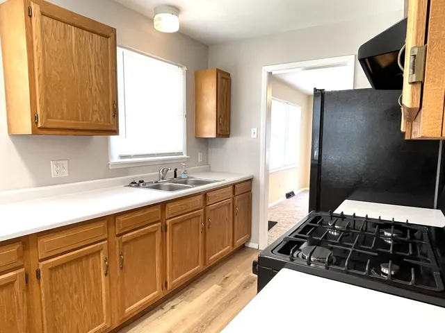 a kitchen with a sink stove and cabinets