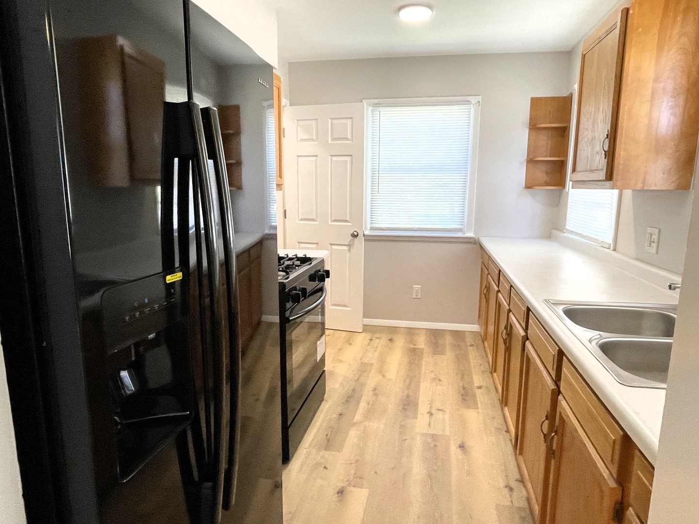 501 East University Avenue Bloomington, IL 61701 - Photo 3 of 21 a kitchen with a refrigerator and a sink