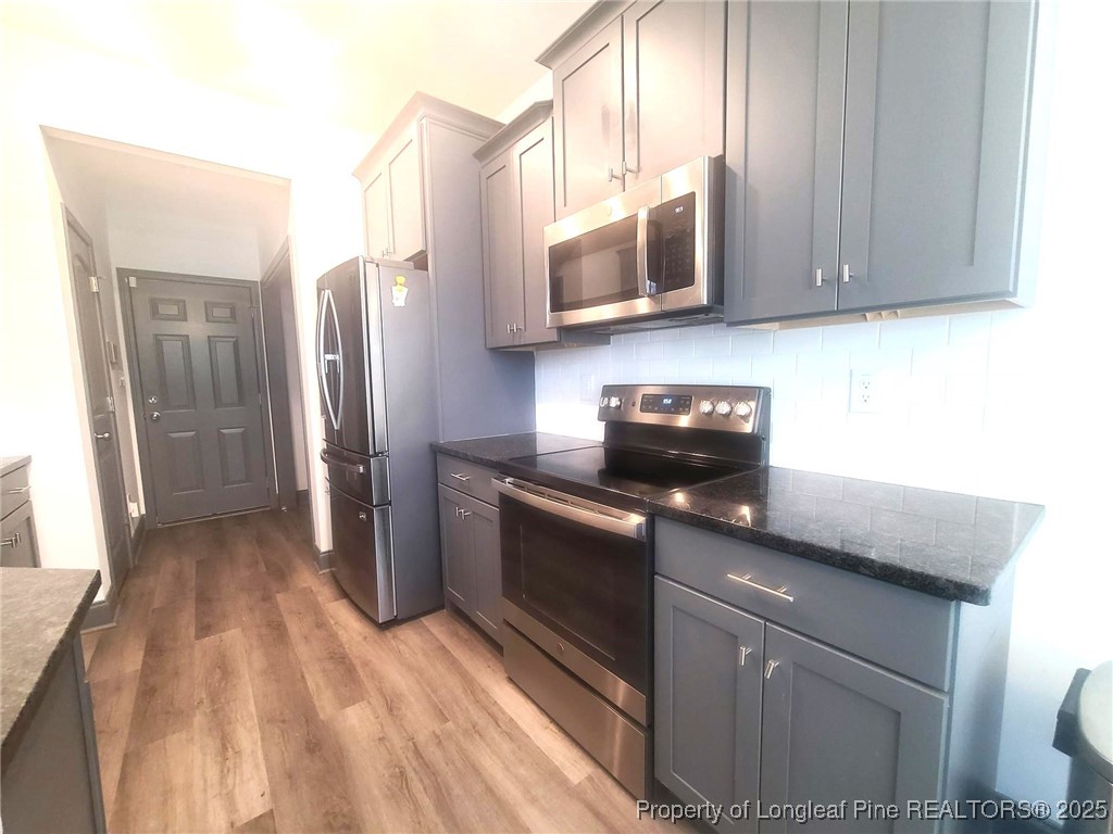 519 Hammond Farms Road Hope Mills, NC 28348 - Photo 11 of 34 a kitchen with stainless steel appliances granite countertop a refrigerator stove and microwave