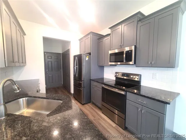 a kitchen with a refrigerator sink and microwave