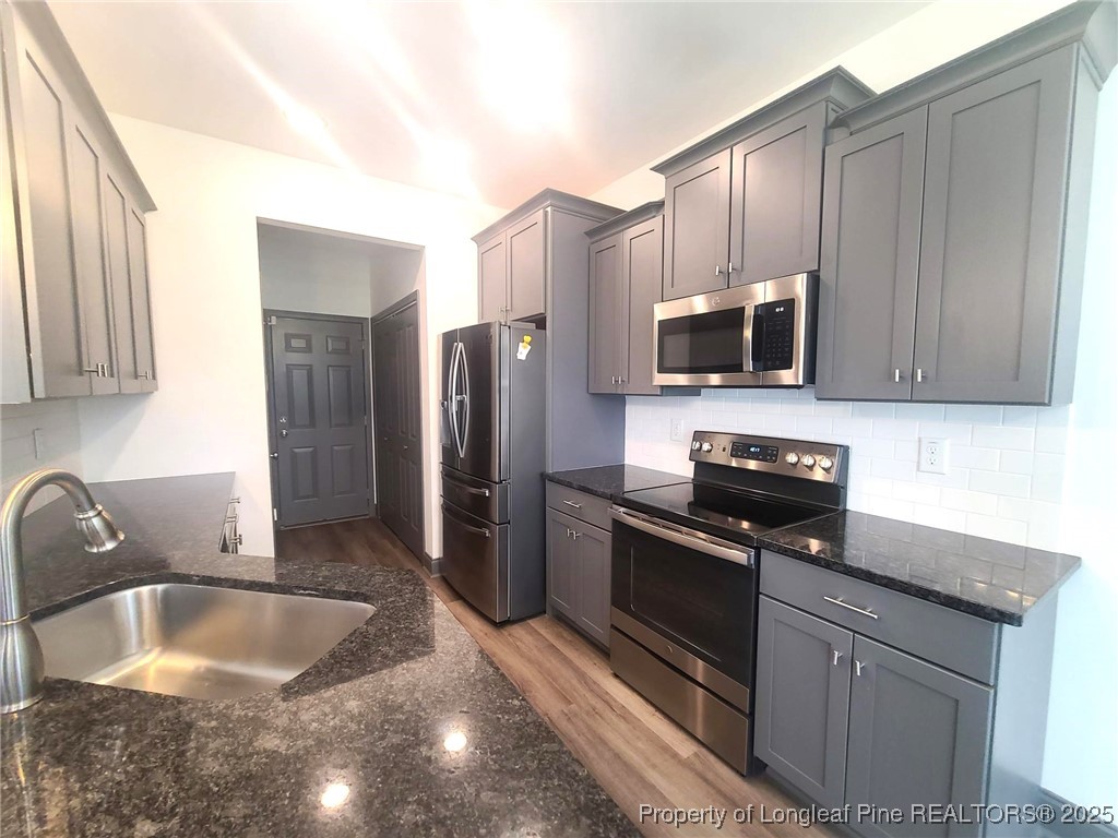 519 Hammond Farms Road Hope Mills, NC 28348 - Photo 14 of 34 a kitchen with a refrigerator sink and microwave