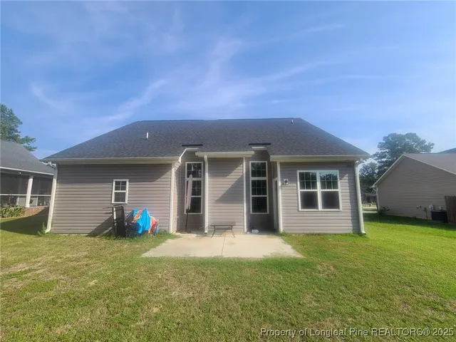 a front view of house with yard and outdoor seating
