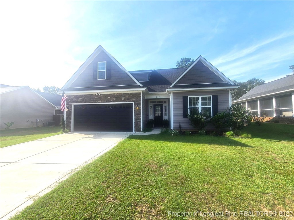 519 Hammond Farms Road Hope Mills, NC 28348 - Photo 2 of 34 a front view of a house with a yard and garage