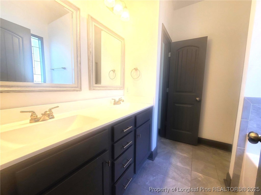 519 Hammond Farms Road Hope Mills, NC 28348 - Photo 21 of 34 a bathroom with a sink and a mirror