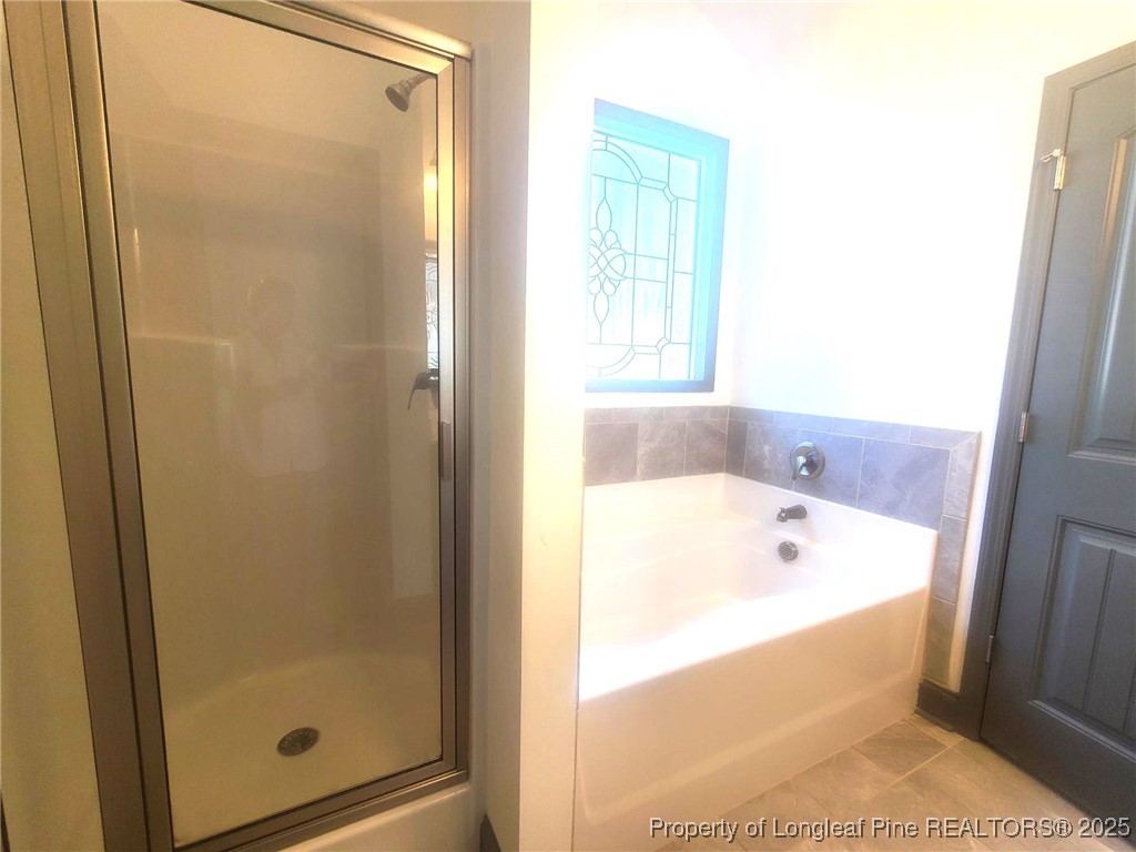 519 Hammond Farms Road Hope Mills, NC 28348 - Photo 22 of 34 a bathroom with a bathtub and shower