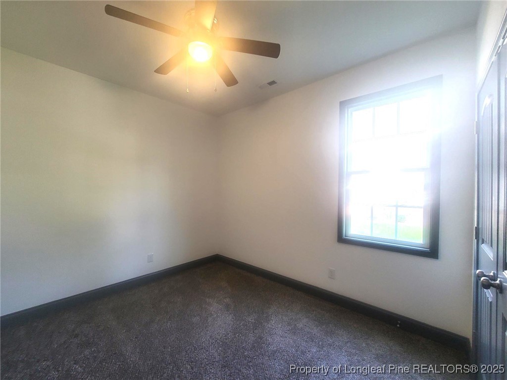 519 Hammond Farms Road Hope Mills, NC 28348 - Photo 25 of 34 an empty room with a window and chandelier fan